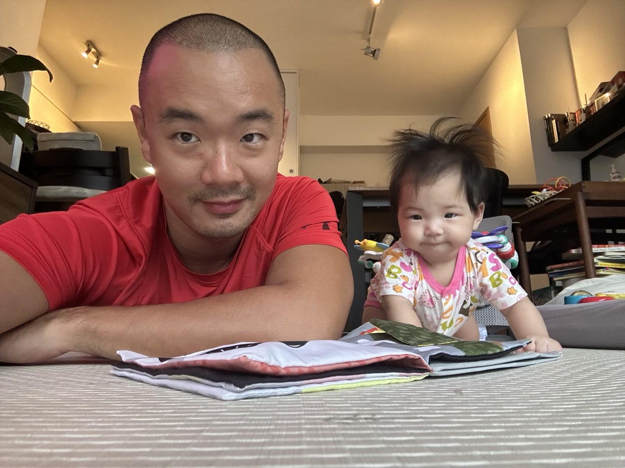 Clement at home with his baby daughter